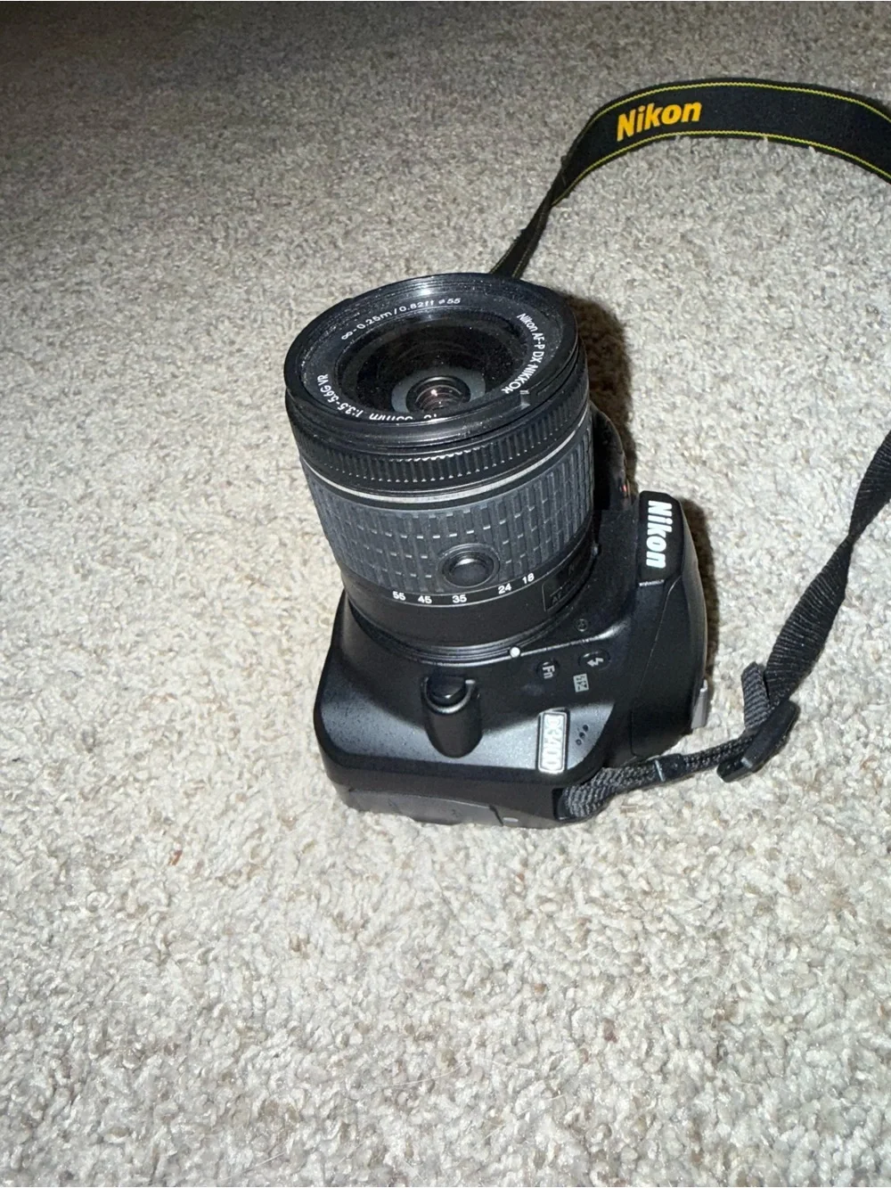 Nikon Black DSLR with Zoom Lens and Branded Neck Strap